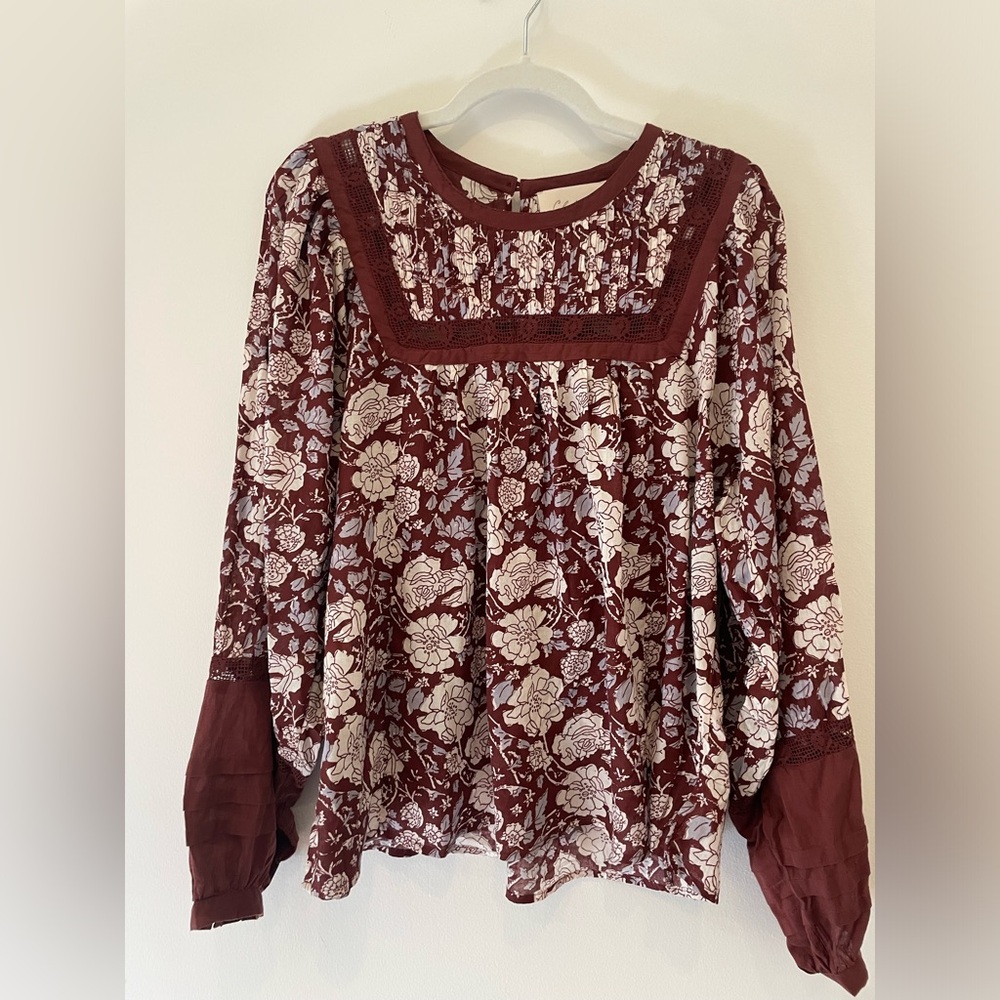 Long sleeve brown floral fall blouse. Ruffle details and buttons.